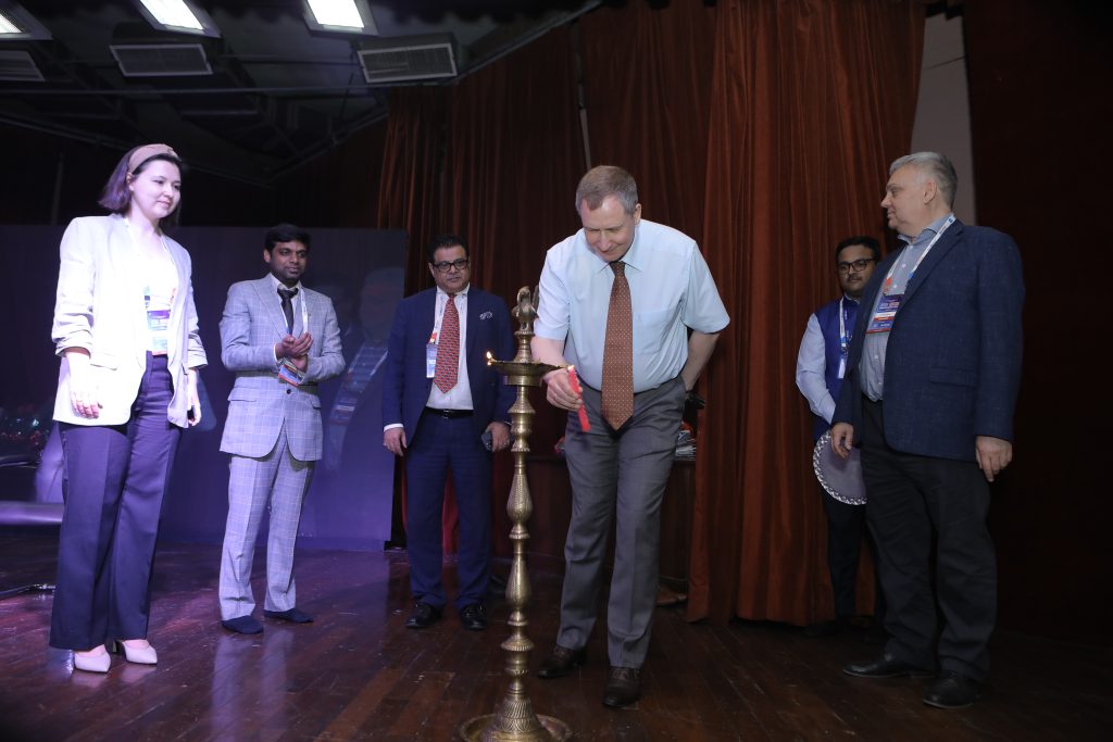 Igor Semenov, Counsellor (Science and Technology) from the Russian embassy lights the ceremonial lamp as (left) Ekaterina Malysheva from Gagarin Cosmonaut Training Centre looks on.